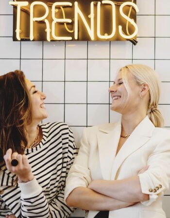 two women discussing the benefits of google ads vs facebook ads for small businesses