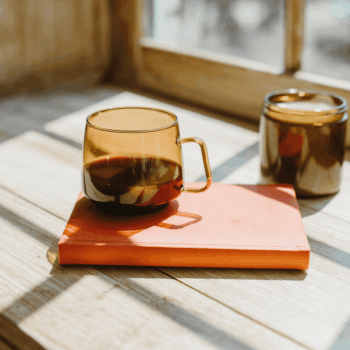 amber cup on top of a coral notebook with notes about what are negative keywords