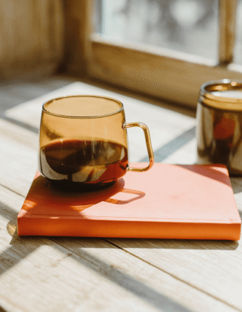 amber cup on top of a coral notebook with notes about what are negative keywords